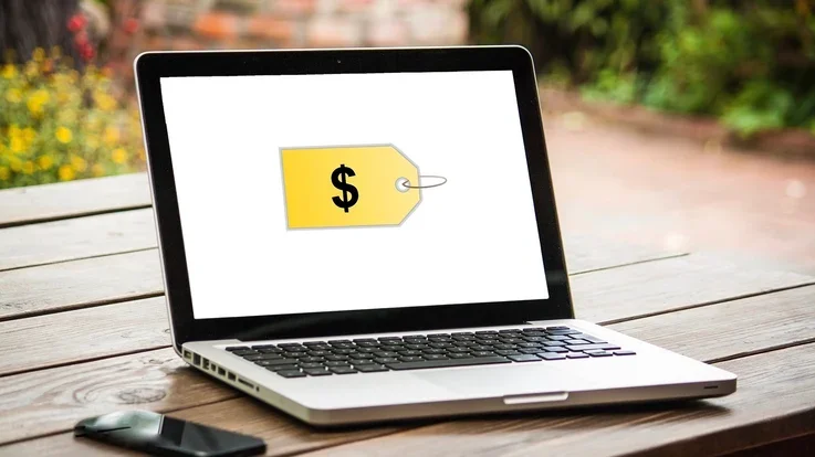 A laptop screen displaying a large price tag, representing pricing a digital product